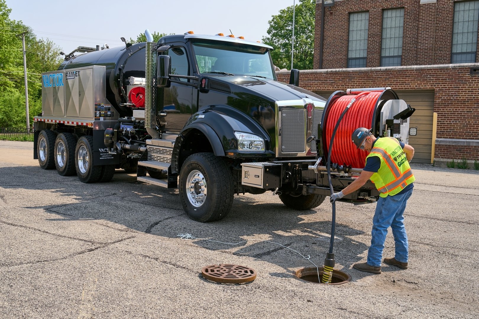  A worker in PPE jetting with a Vactor Ramjet Truck