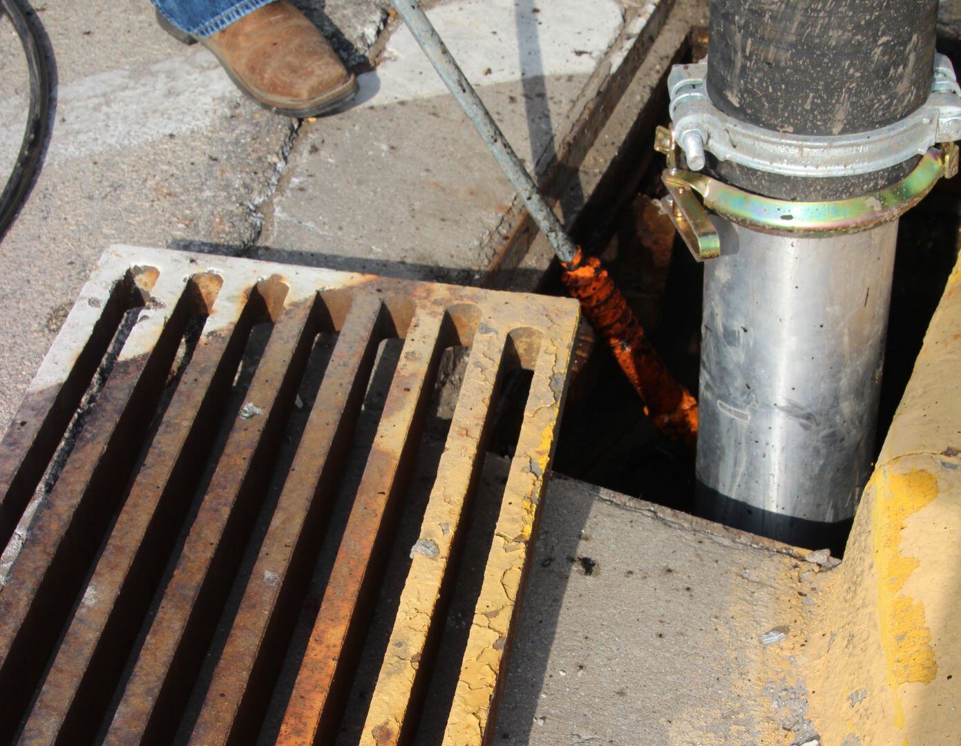 A Vactor Truck boom and lance working in a storm drain