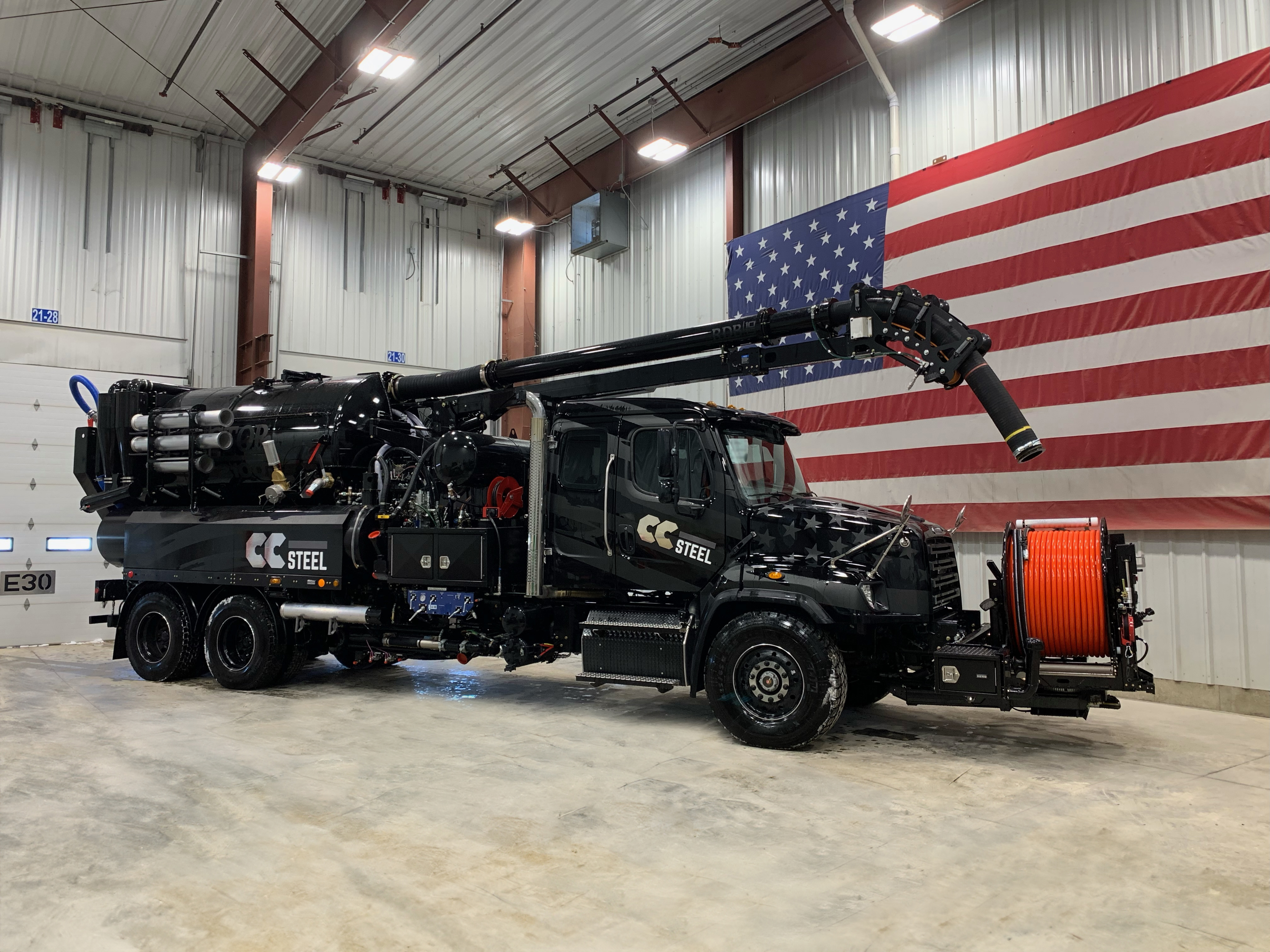 A Vactor Truck boom and lance working in a storm drain